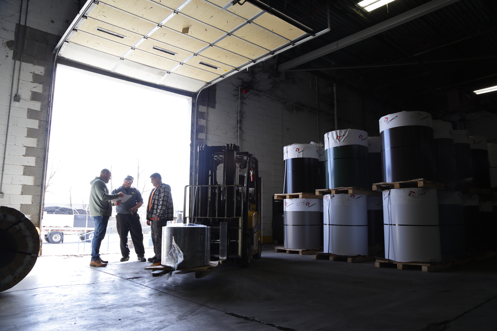 alt="Warehouse distributors actively discussing where supplies will be heading to"