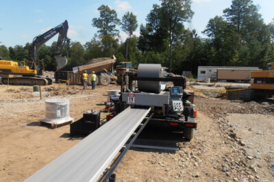 A view on a construction site of a rollformer in action.