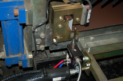 A close-up image of a mechanical seam nozzle on a rollformer.